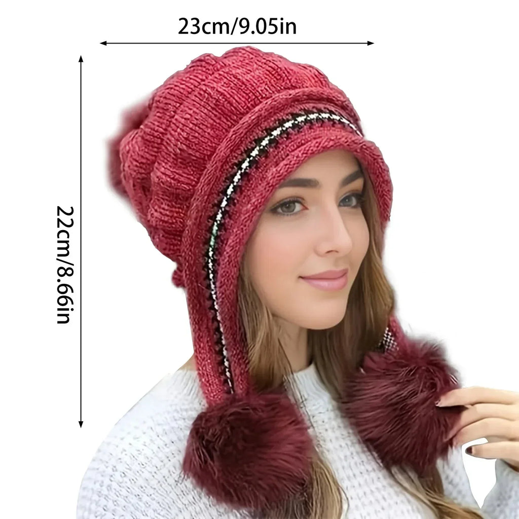 Women's pom-pom beanie styled as a cozy cold-weather accessory
